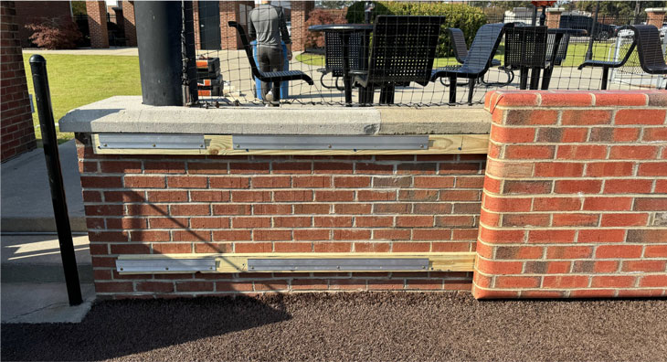 Brick Look Custom Graphic Backstop Padding at Jim Perry Stadium by Field Wall Pads